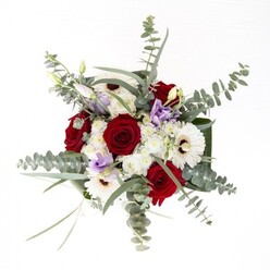 Through the eyes of a seasoned Shadwell florist, this bouquet stands as an emblem of subtle confidence, hand-crafted to channel the timeless allure of local blooms. Creamy white gerbera daisies, radiant from their espresso-hued centres, anchor the ensemble and radiate outward with palpable presence. Nestled alongside, the bouquet's robust red roses bring depth and romance, their spiral petals evoking enduring connection. Floating overhead are silvery discs of eucalyptus, their delicate leaves catching soft light and hinting at moments spent beneath leafy canopies in Shadwell Basin Park. Lilac-hued lisianthus-both in bud and blossom-scatter unique colour throughout, offering a contemporary touch with a gentle, hope-filled energy. Cloud-like clusters of white fillers lend texture and fullness, blending seamlessly into the surrounding broad, sculptural greenery that cradles the entire arrangement. Every stem is expertly arranged and immersed in crystal water, visible through a clean glass vase that invites admiration of the bouquet's foundation. Whether placed on a mantelpiece in Wapping or accompanying a thoughtful message to a loved one, this arrangement expresses the genuine artistry and personal care synonymous with Shadwell's trusted florists.